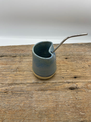 Ceramic mug with a straw