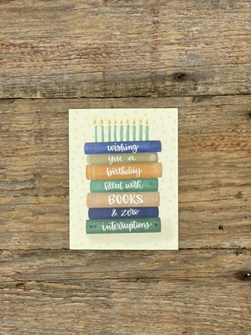 Greeting card with book stack design on a wooden surface
