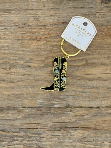 Cowboy boot keychain with floral designs on a wooden surface, branded 'PikaBear'.