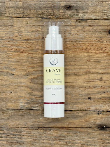 Skincare bottle labeled 'Crave' on a wooden surface