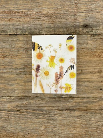Card with floral design on a wooden surface