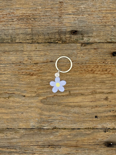 Flower-shaped keychain on a wooden surface