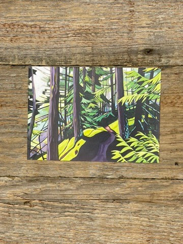 Postcard with a forest design on a wooden surface