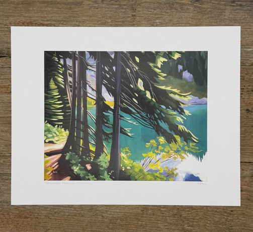 Art print of a forest scene with trees and foliage on a wooden surface