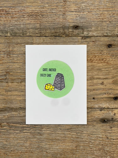 Card with a green circle and text on a wooden surface
