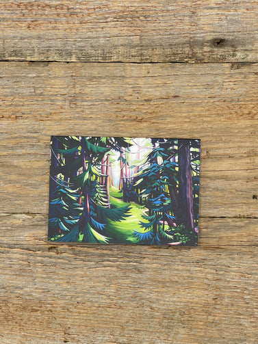 Forest scene postcard on a wooden surface