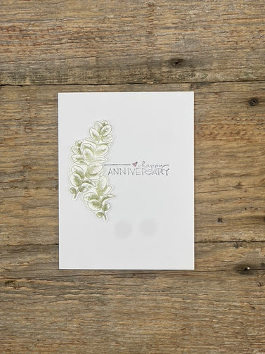 White card with decorative text and design on a wooden surface