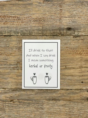 Card with humorous text about drinking habits on a wooden background