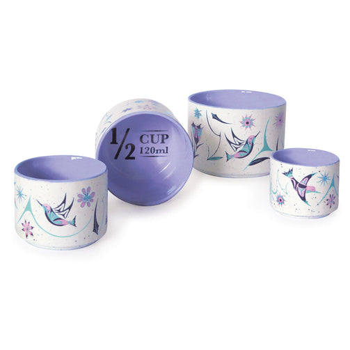 Set of four measuring cups with floral designs, hummingbirds and measurement markings on a white background