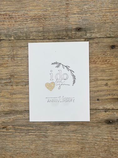 White card with 'i do love you' text and heart on a wooden surface