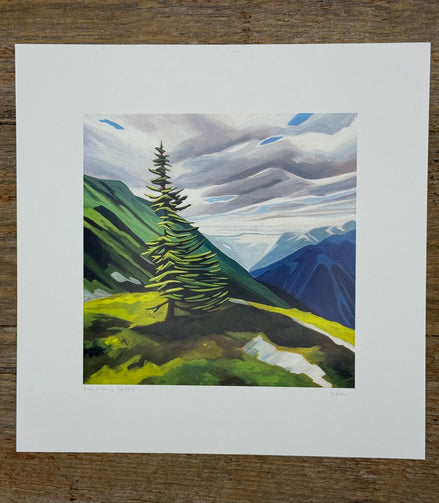 Painting of a mountain landscape with a prominent tree on a wooden surface