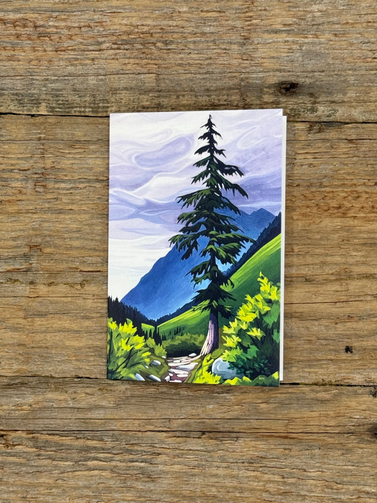 Painting of a landscape with trees and mountains on a wooden surface