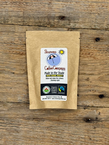 Kraft paper coffee package with a label on a wooden surface