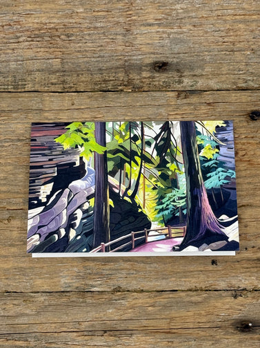 Painting of a forest scene on a wooden surface