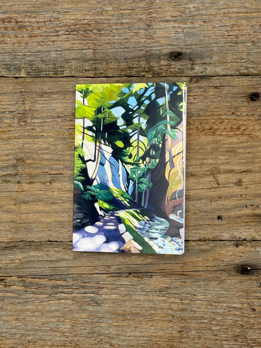 Painting of a forest scene on a wooden surface