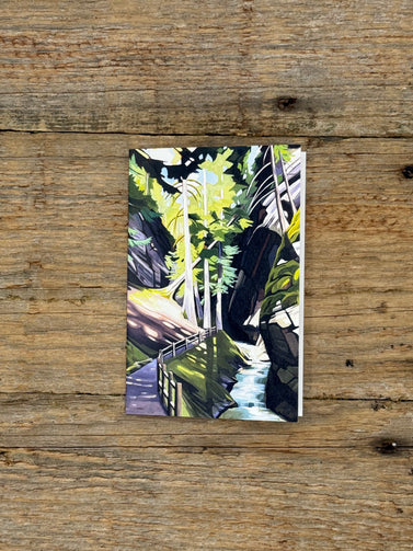 Artistic depiction of a forest scene on a wooden surface
