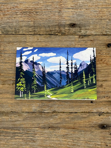 Painting of a mountain landscape with trees on a wooden surface