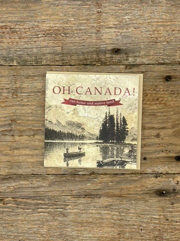 Card with 'OH CANADA!' text and nature illustration on a wooden surface