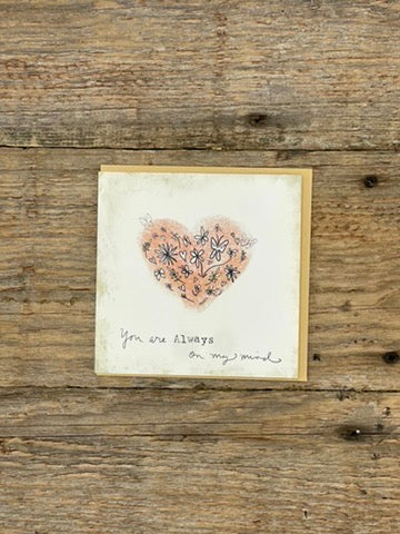 Card with a heart design and text on a wooden surface