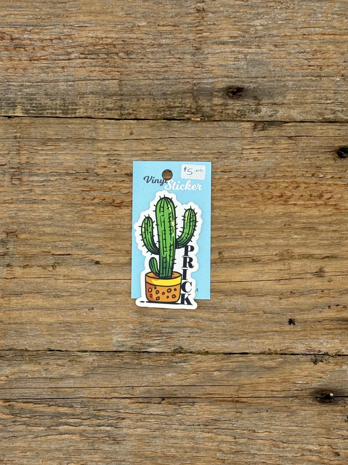 Cactus-shaped vinyl sticker on a wooden surface