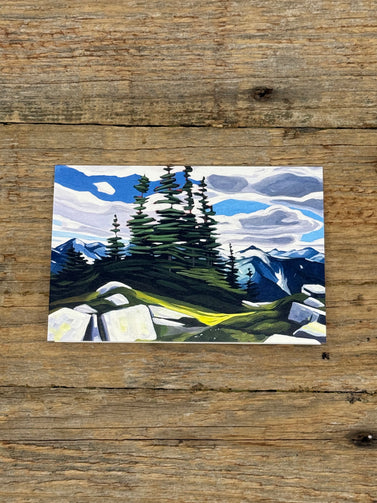 Painting of a mountain landscape with trees and rocks on a wooden surface