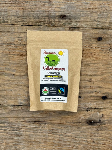 Kraft paper coffee bag with a label on a wooden surface Shuswaggi Coffee