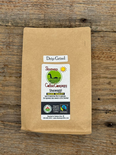 Kraft paper coffee bag with Shuwap Coffee Company label on a wooden surface