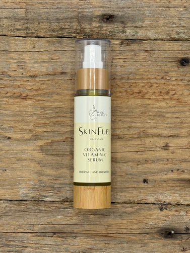 Skin Fuel Organic Vitamin C+Elixir bottle on a wooden surface