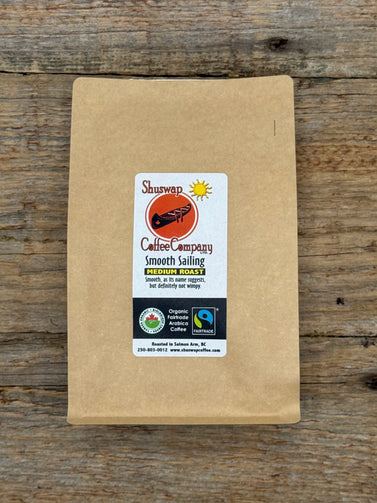Kraft paper coffee bag with Shuswap Coffee Company label on a wooden surface