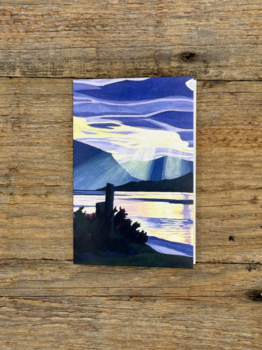 Artistic depiction of a mountain landscape on a wooden surface