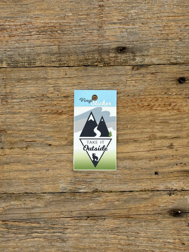 Vinyl sticker with mountain design on a wooden surface