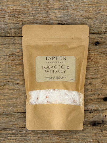 Tappen Apothecary Tobacco & Whiskey bath salts packaging on a wooden surface