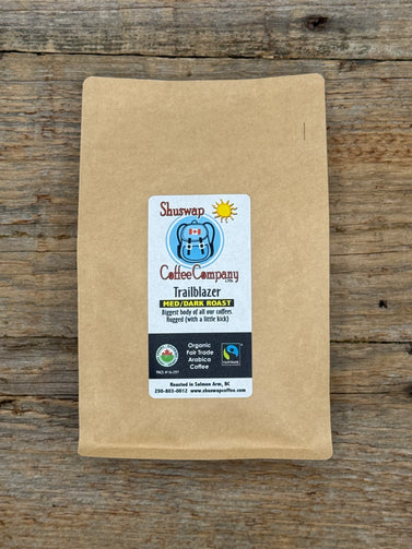Kraft paper coffee bag with Shuswap Coffee Company label on a wooden surface