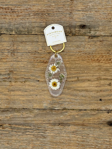 Keychain with pressed flowers on a wooden surface