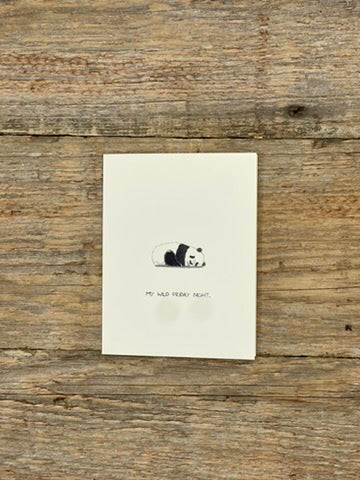 Note card with panda illustration and text on a wooden surface