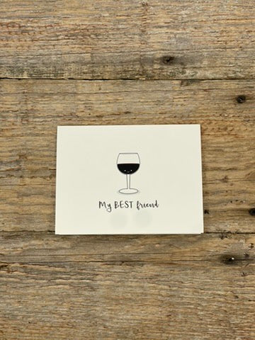 Note card with a wine glass illustration and text 'My BEST friend' on a wooden surface