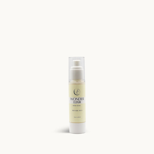 A pump bottle of face cream labeled 'Wonder Elixir' from Wild Beauty.