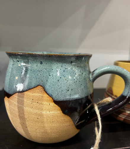 ceramic mug with unique design on a dark surface.
