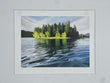 Framed artwork of a lake with trees and mountains