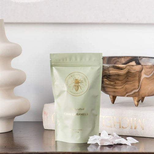 Packaged product on a wooden surface with decorative items in the background