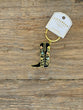 Cowboy boot keychain with floral designs on a wooden surface, branded 'PikaBear'.