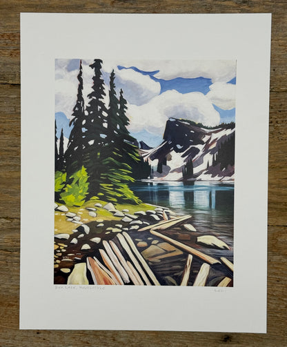 Painting of a mountain landscape with a lake and dock on a wooden surface