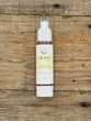 Skincare bottle labeled 'Crave' on a wooden surface