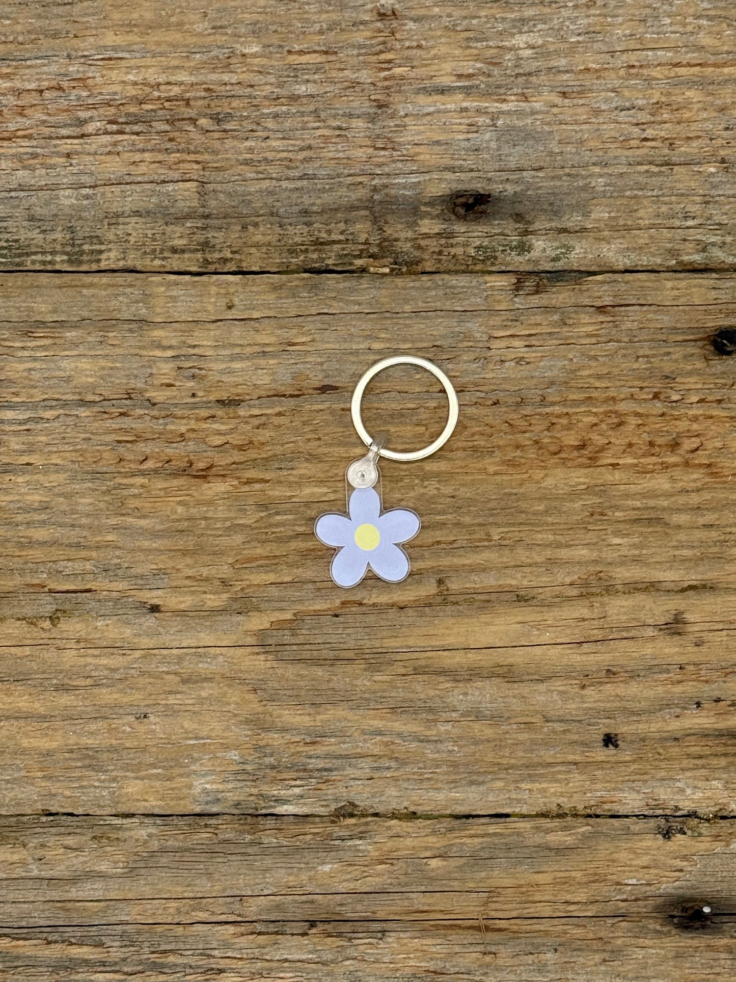 Flower-shaped keychain on a wooden surface