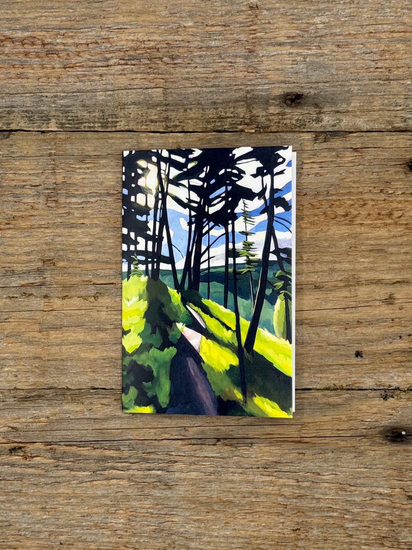 Painting of a forest scene on a wooden surface