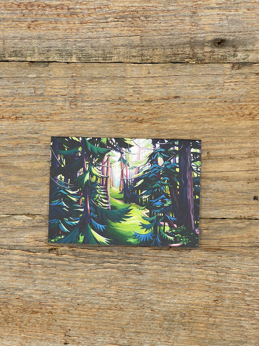 Forest scene postcard on a wooden surface