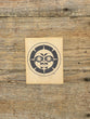 Wooden block with a Haida Moon design on a wooden surface