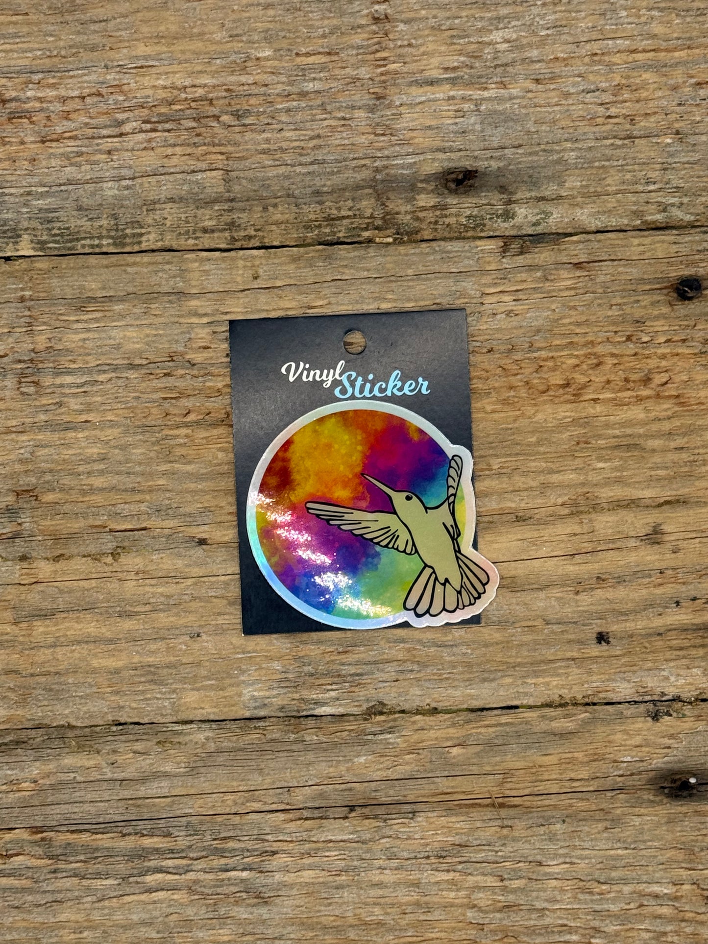 Colorful vinyl sticker on a wooden surface