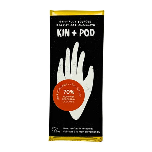 Kin + Pod chocolate bar packaging with a black background and white hand illustration.