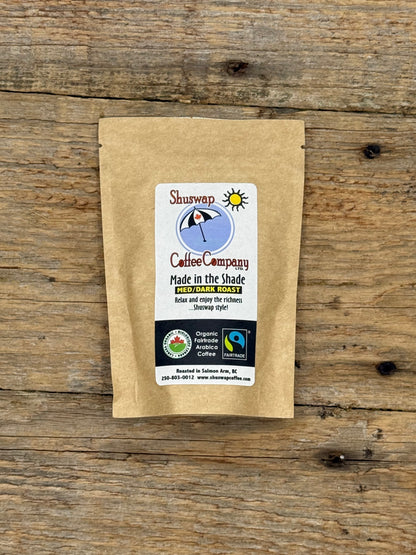 Kraft paper coffee package with a label on a wooden surface